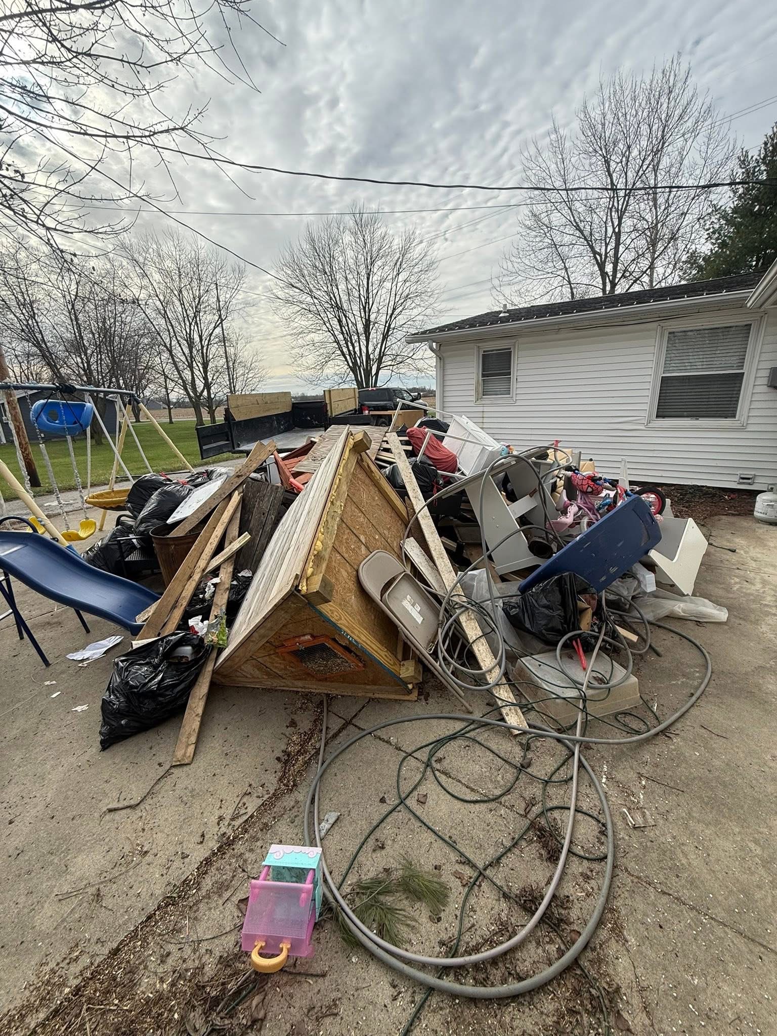 Before: storm debris and structural material piled on site